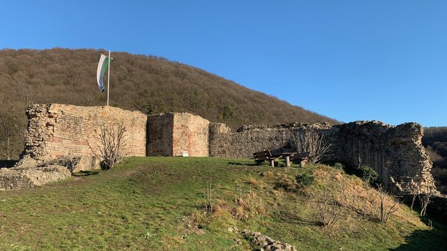 Burgruine Schauenburg bei blauen Himmel mit wehende grün-weiß gestreifter Flagge